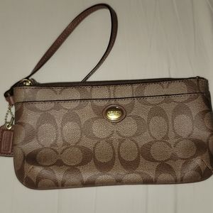 Never been used brown, leather Coach wristlet.